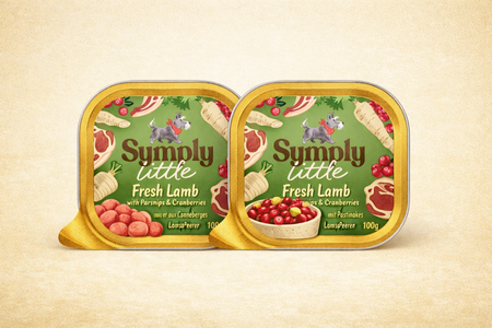 Two tins of 'Simply Little Fresh Lamb' pet food on a beige background