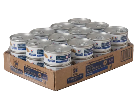Cardboard box filled with cans of Hill's Science Diet pet food on a beige background
